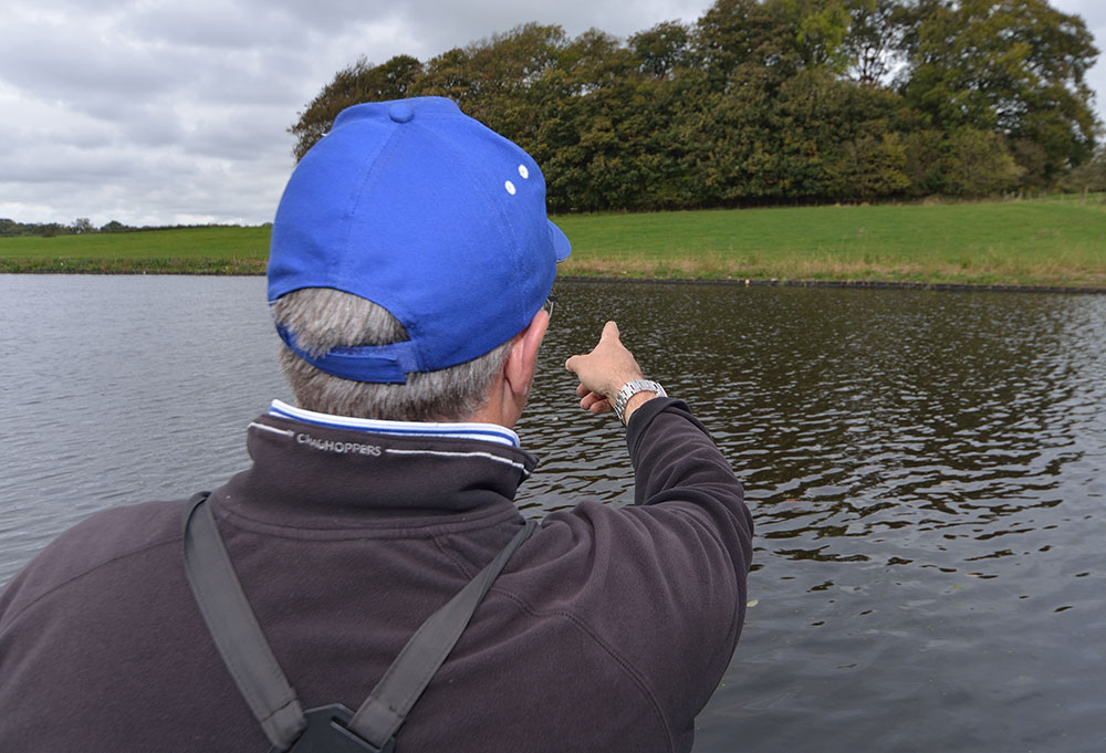 Alan points to his marker which is the white object on the far bank