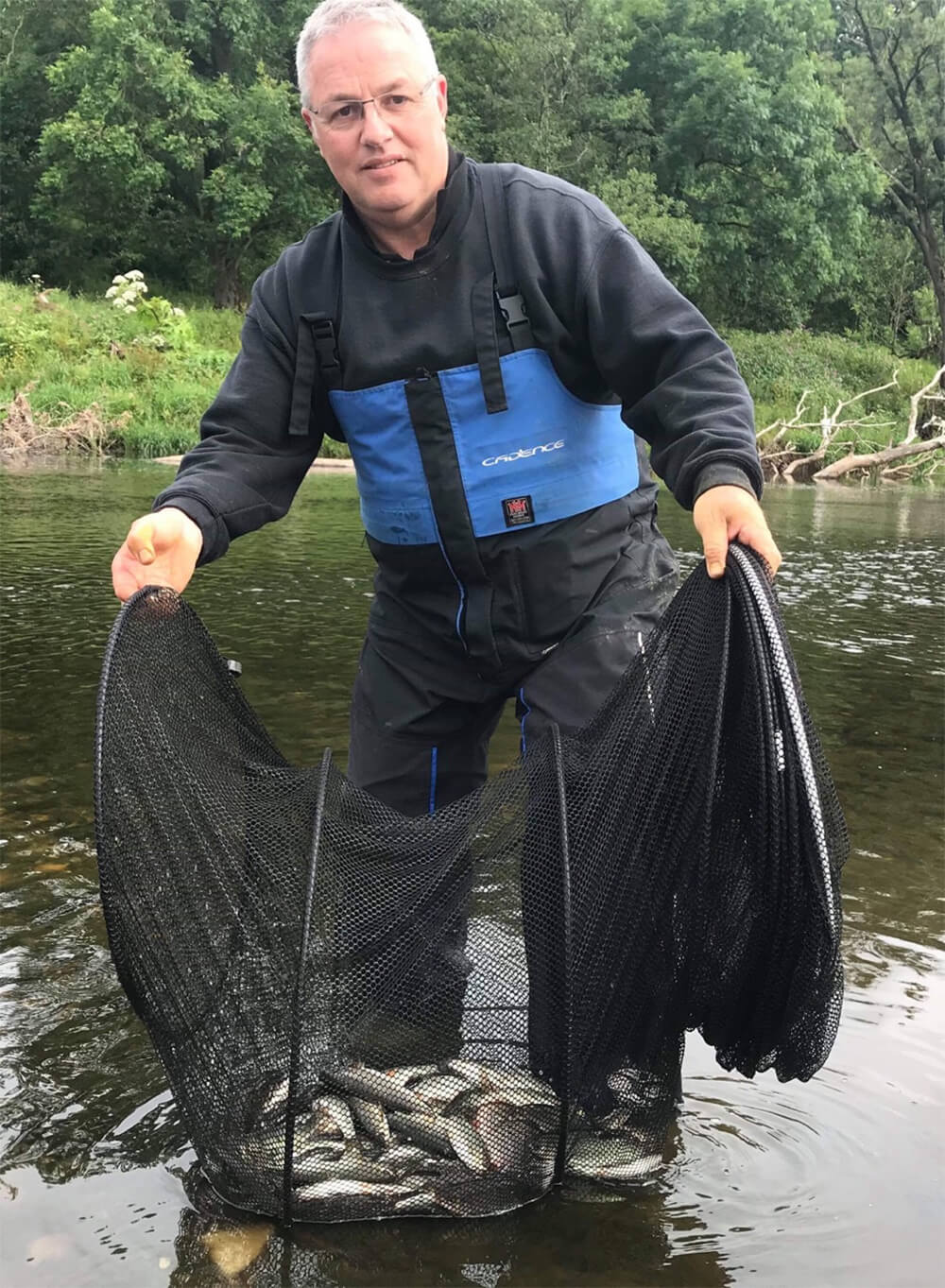 FAST WATER REWARD: Alan with a welcome summer catch of chublets, dace and roach taken in three frenetic hours targeting a swim up against dead, far bank trees, using the Cadence 13ft #3 match rod.